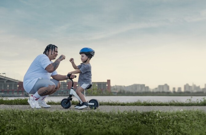 Father and son doing a fist bump outside